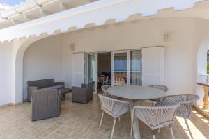 a living room with a table and chairs at Villa Sea Lights 89b in Son Bou
