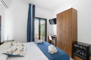 a bedroom with a bed with towels on it at Bnb La Rocca San Vito Lo Capo in San Vito lo Capo