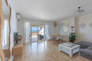 a living room with a couch and a table at Villa Sea Lights 89b in Son Bou