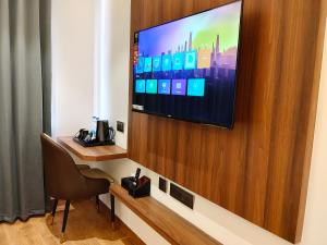 a room with a flat screen tv on a wall at L G Cordial in Mysore