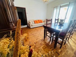 a living room with a table and a couch at Suite Excelsior - Bordighera in Bordighera