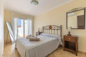 a bedroom with a bed with a mirror and a dresser at Villa Sea Lights 89b in Son Bou +20 photos