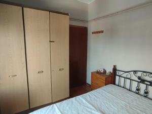 a bedroom with a bed and two closets at Fiorela Gest House in Kalabaka