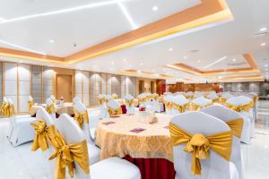 a banquet hall with white chairs and tables with bows at Lords CBC Plaza Chitwan in Bharatpur