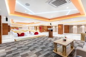 a lobby of a hotel with tables and chairs at Lords CBC Plaza Chitwan in Bharatpur