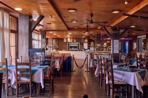 a restaurant with tables and chairs and a kitchen at Pirates Village in Santa Ponsa
