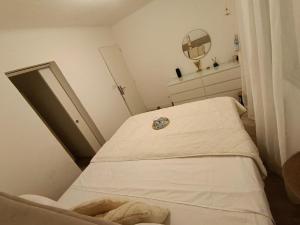a small room with a hospital bed and a mirror at Maison spacieuse in Saint-Julien-de-Concelles
