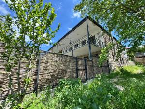 a building on top of a brick wall at Dusheti Retreat - Authentic Georgian Living in Dushetʼi
