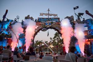 a group of people sitting in chairs in front of a stage at Pirates Village in Santa Ponsa +58 photos