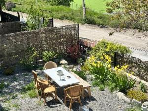 a table and chairs sitting in a garden at Dusheti Retreat - Authentic Georgian Living in Dushetʼi +32 photos