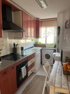 a kitchen with red cabinets and a sink and a table at Lydia Cabo Cope in Calabardina +16 photos