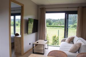 a living room with a white couch and a large window at LA TIERRUCA HOMES in Barcenaciones