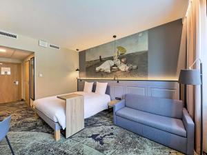 a hotel room with a bed and a couch at Mercure Wrocław Centrum in Wrocław +284 photos