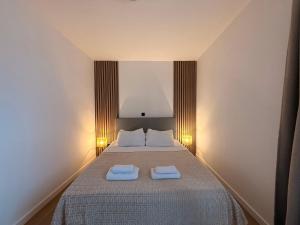 a bedroom with a bed with two towels on it at Villa Veronika in Lovran