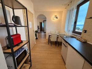 a kitchen and living room with a table and chairs at Villa Veronika in Lovran