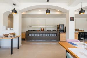 a kitchen with a table and a counter at Hotel Coral Boutique by gaiarooms in L'Estartit +2 photos