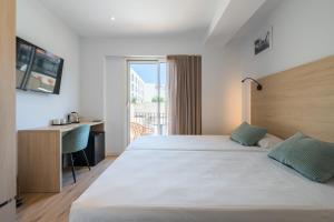 a hotel room with a large bed and a desk at Hotel Coral Boutique by gaiarooms in L'Estartit