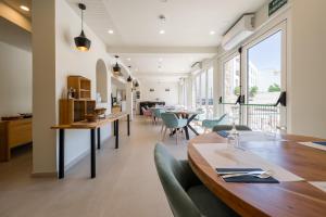 a dining room with a long table and chairs at Hotel Coral Boutique by gaiarooms in L'Estartit