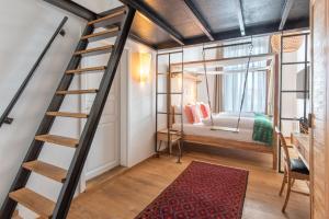a room with a staircase and a bedroom with a bed at Lulu Guldsmeden in Berlin +46 photos