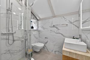 a bathroom with a shower and a toilet and a sink at Solis Rooms Old Town in Dubrovnik +37 photos