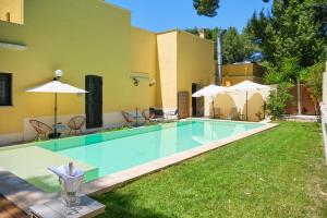 a swimming pool in the backyard of a house at Dimora Relais Excelsa in Gallipoli