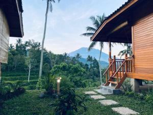 a porch of a house with a mountain in the background at Pandawa Villa Sidemen in Karangasem