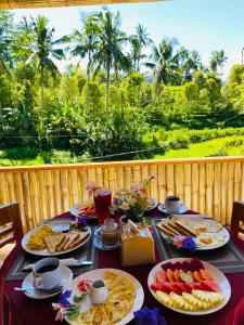 a table with plates of food on it with a view at Pandawa Villa Sidemen in Karangasem