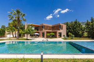 a large swimming pool in front of a house at Fllad e Valë Luxury Private Pool Villa by PikHost in Tragjas