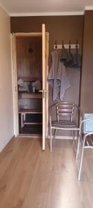 a room with a chair and an open door at Staltbrieži in Ratnieki
