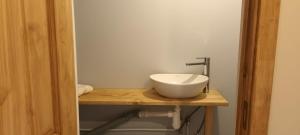 a bathroom with a white sink on a wooden counter at Staltbrieži in Ratnieki +12 photos
