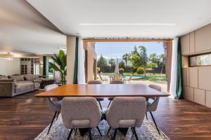 a dining room with a wooden table and chairs at Fllad e Valë Luxury Private Pool Villa by PikHost in Tragjas