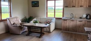 a living room with two chairs and a table at Staltbrieži in Ratnieki