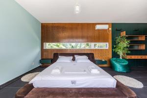 a bedroom with a large bed and a window at Fllad e Valë Luxury Private Pool Villa by PikHost in Tragjas +82 photos