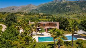 an aerial view of a house with a swimming pool at Fllad e Valë Luxury Private Pool Villa by PikHost in Tragjas