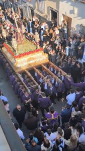 a large crowd of people standing around a large cake at Casa Juanito Rute in Rute
