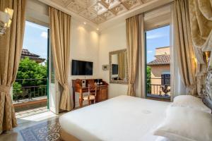 a bedroom with a bed and a large window at Hotel Aventino in Rome