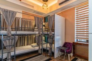a room with two bunk beds and a chair at TURQUOISE Hostel in Bucharest