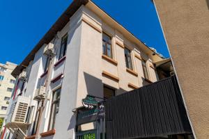 a building with a gate in front of it at TURQUOISE Hostel in Bucharest