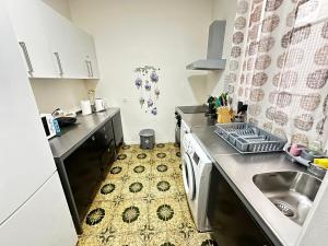 a small kitchen with a sink and a dishwasher at Rooms Diputacion in Barcelona
