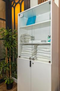 a white closet with towels in it at TURQUOISE Hostel in Bucharest
