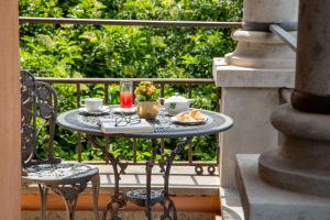 a table with a tray of food on a balcony at Hotel Aventino in Rome