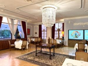 a dining room with a table and a chandelier at Hotel Radmilovac in Belgrade