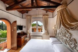 a bedroom with a bed and a desk and a window at Hotel Aventino in Rome