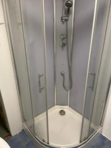 a shower with a glass door in a bathroom at Gîte de la cathédrale in Condom