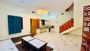 a living room with a table and stairs at The Ocean Crown in Udupi