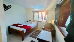 a small bedroom with a bed and a window at The Ocean Crown in Udupi +78 photos