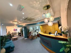 a lobby with a reception desk in a building at Elysee Hyde Park in London