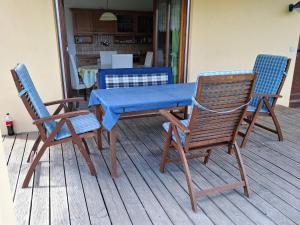 a wooden table and chairs with a blue table and chairs at FW Körner in Zwiesel