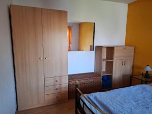 a bedroom with a bed and a cabinet and a mirror at FW Körner in Zwiesel