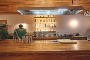 a bar with a man standing behind the counter at Urban Pod Capsule Hostel in Bangkok